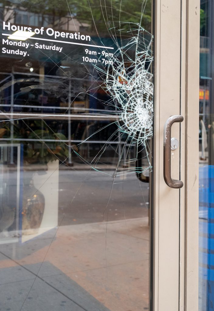 Broken,Shattered,Window,On,Store,Front,Aluminum,Door,From,Vandals.